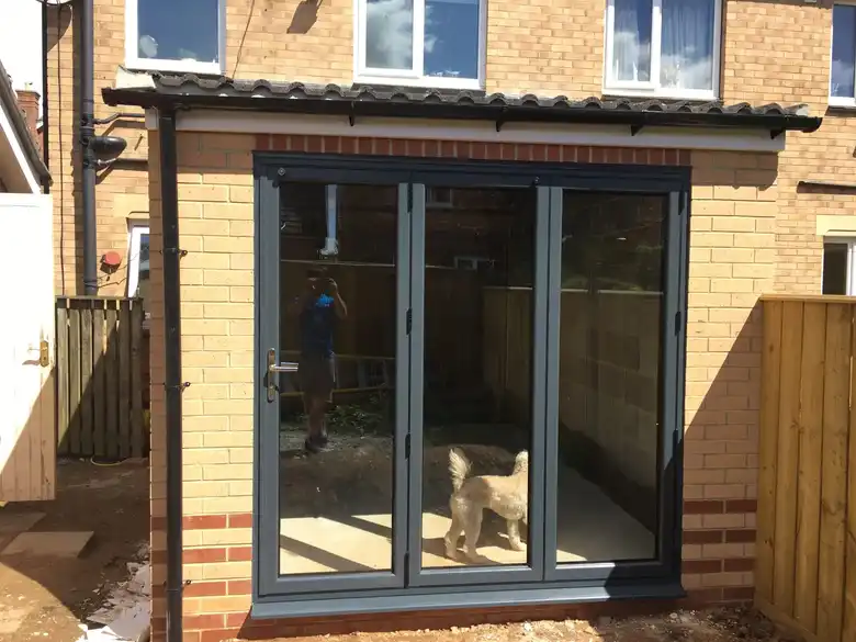 Aluminium bifold doors in a brick extension
