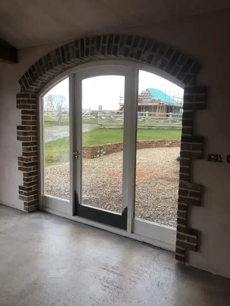 Arched glazed door in a stone barn