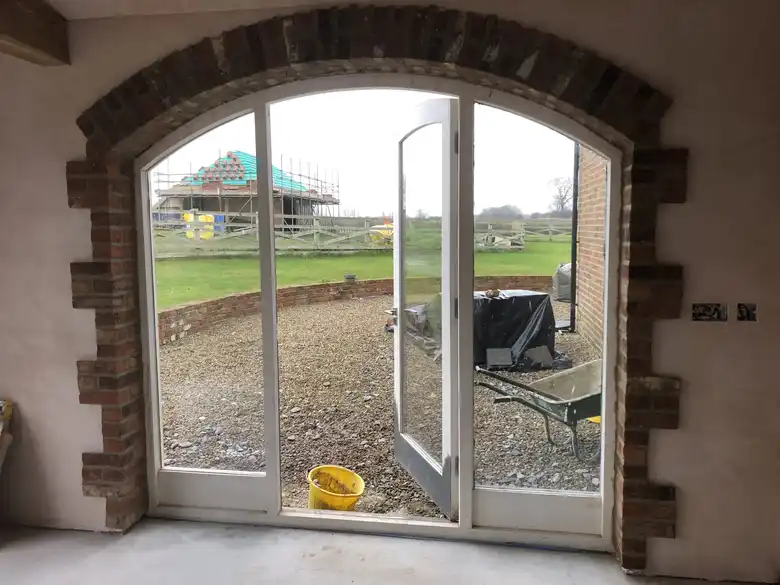 Arched glazed doors in a stone barn