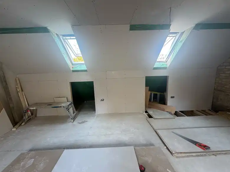 Attic room boarded under two rooflights