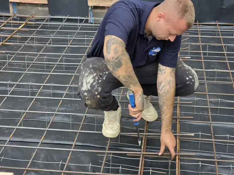 Barlow team member fixing steel reinforcement mesh