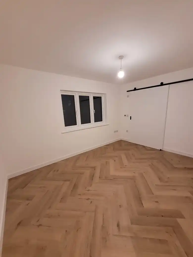 Bedroom with a herringbone floor