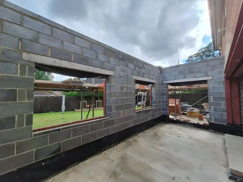 Blockwork walls of the new extension with window openings