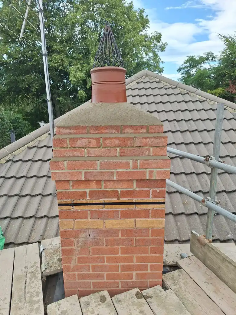 Brick chimney stack rebuilt on scaffold