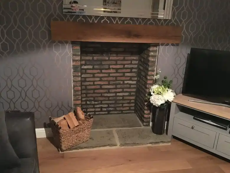 Brick fireplace with oak beam