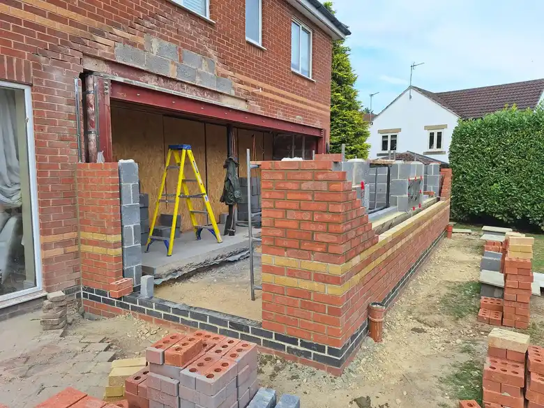 Bricklayer at work on the extension