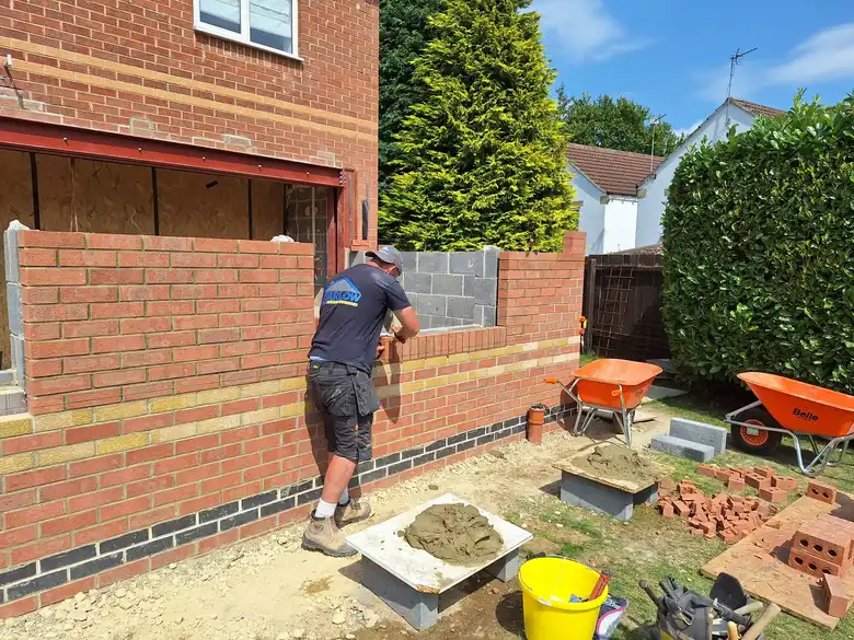 Bricklayer working on the extension