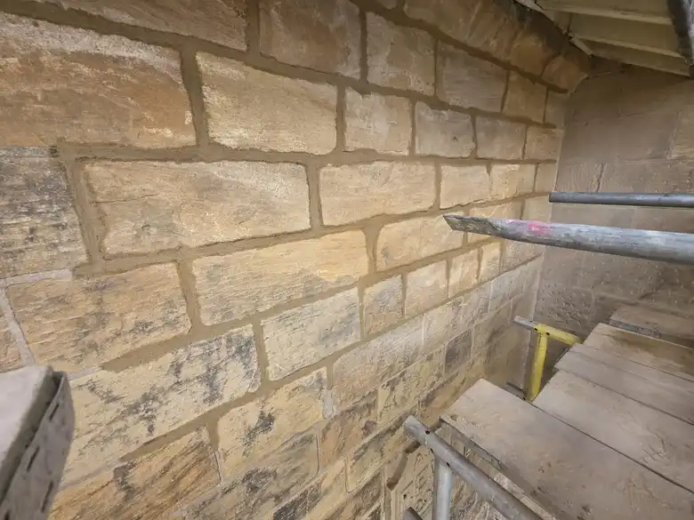 Coursed sandstone repointed in lime