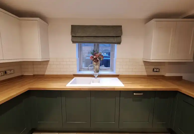 Green shaker kitchen with oak worktops
