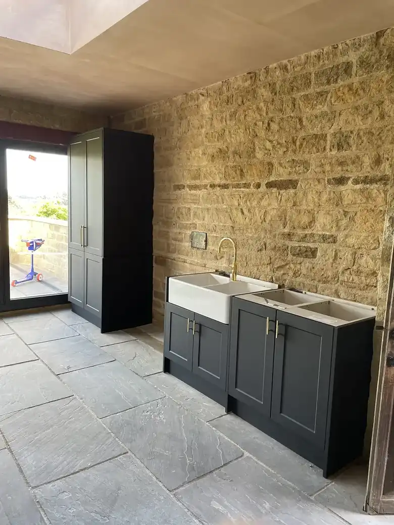 Kitchen against an exposed stone wall