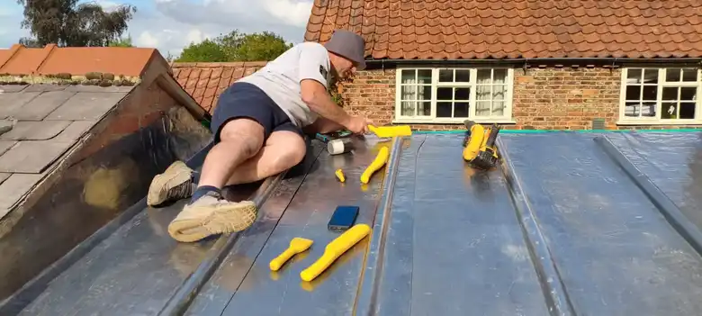 Leadworker fitting a lead roll roof