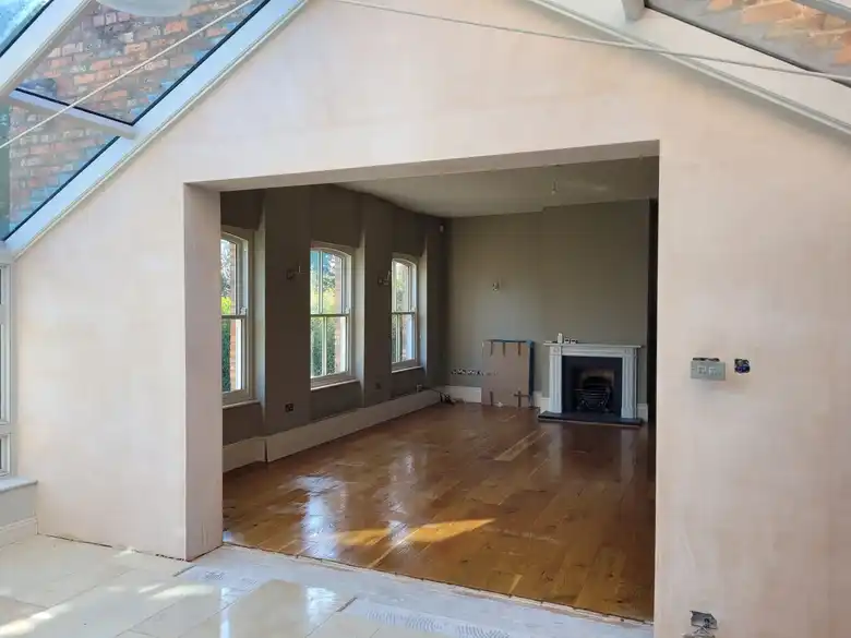 Renovated living room opening into a garden room