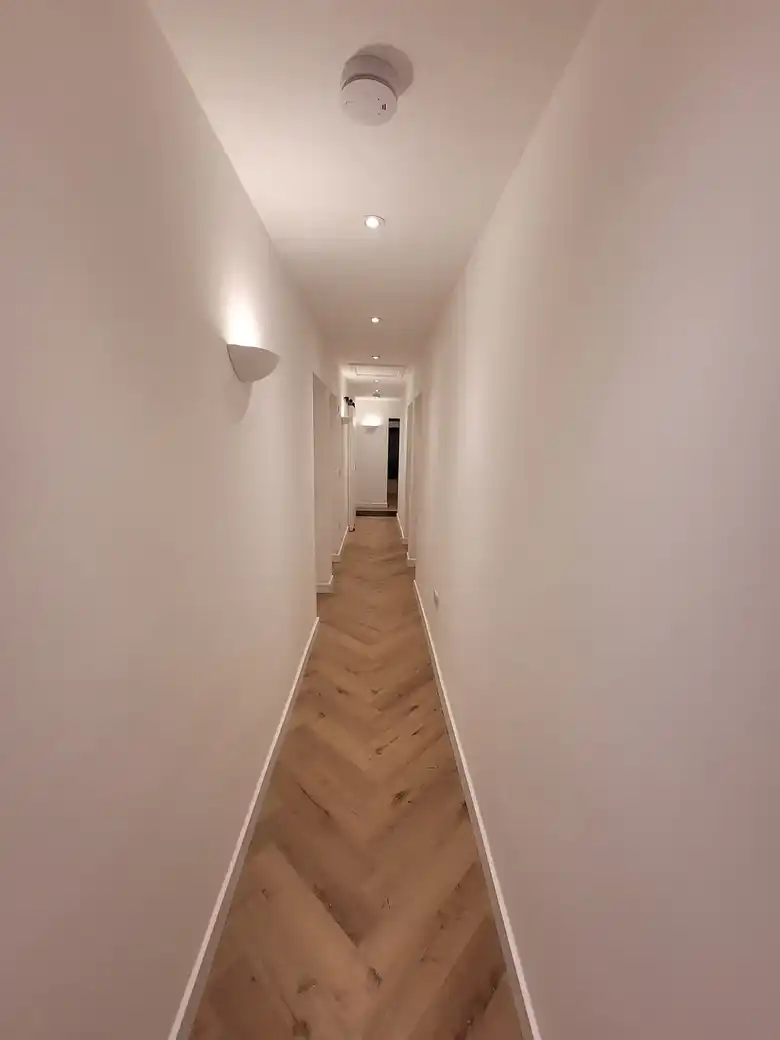 Long hallway with herringbone floor