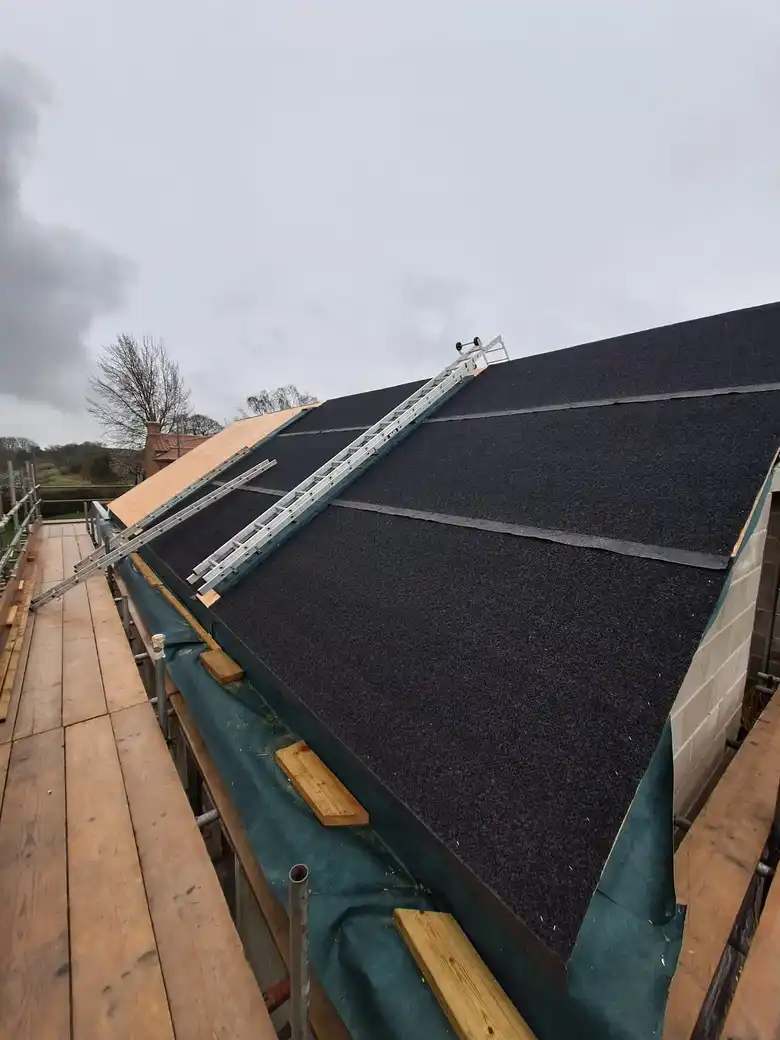 New slate roof being laid over membrane