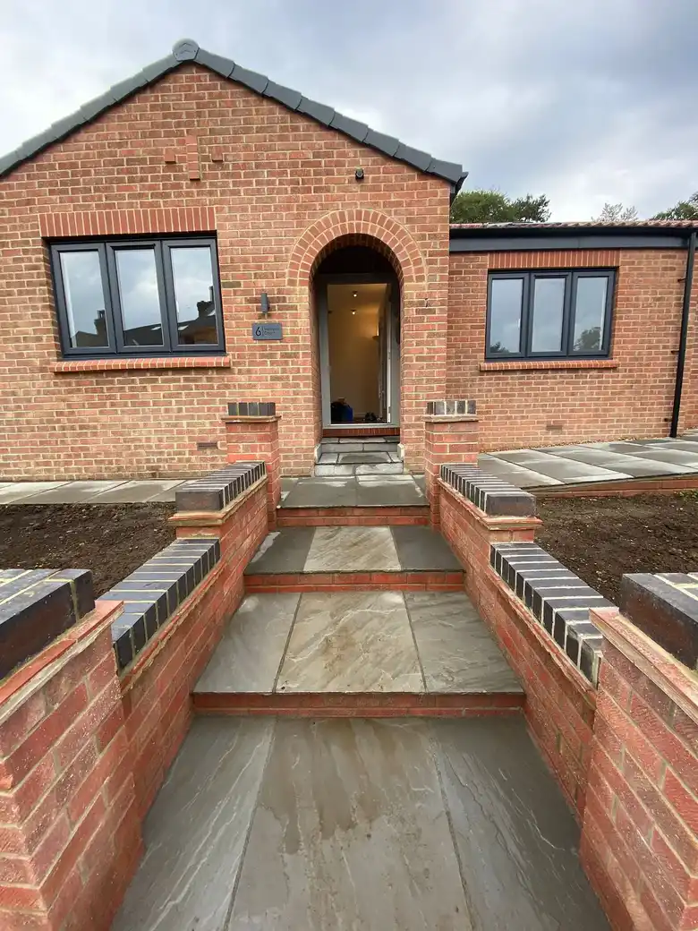 New steps and brick walls at the front door