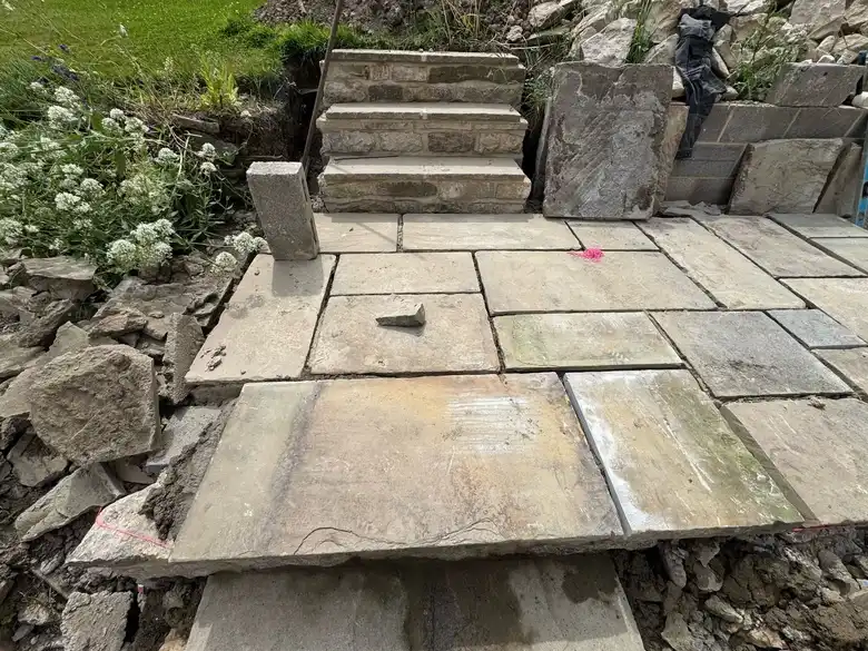 New terrace with stone steps up to the garden