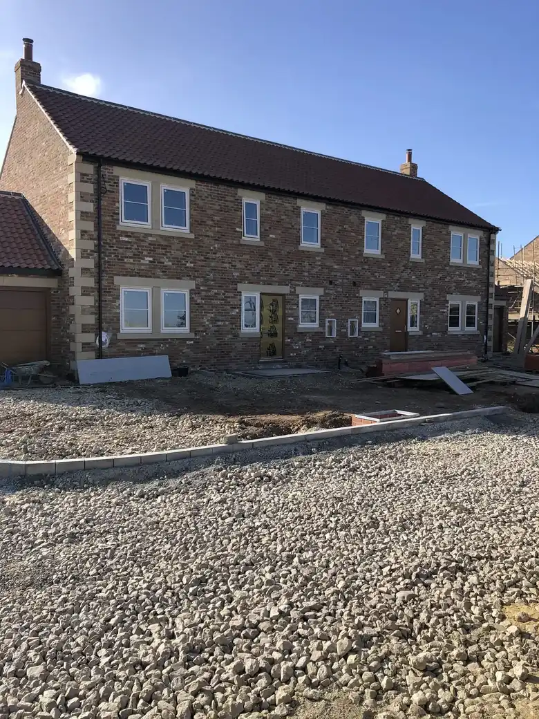 Pair of brick houses with stone quoins and sills