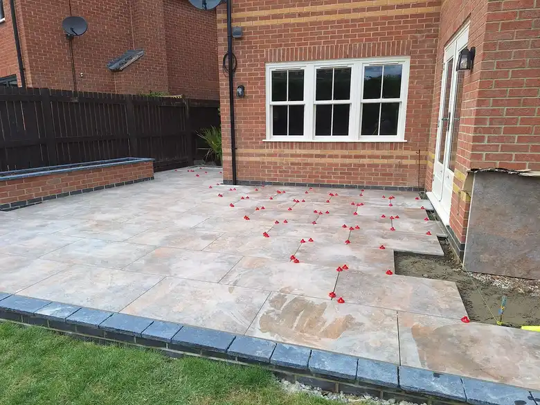 Porcelain patio at the back of a brick house