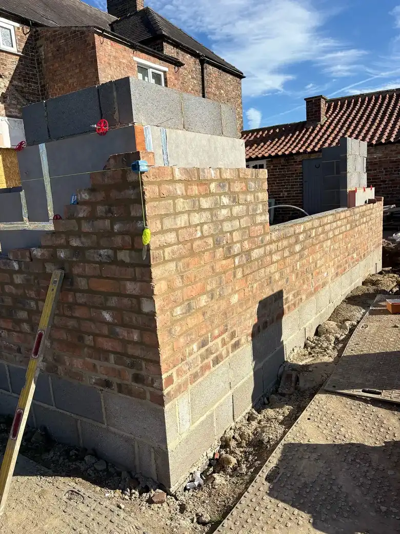 Red brick facing going up at the corner