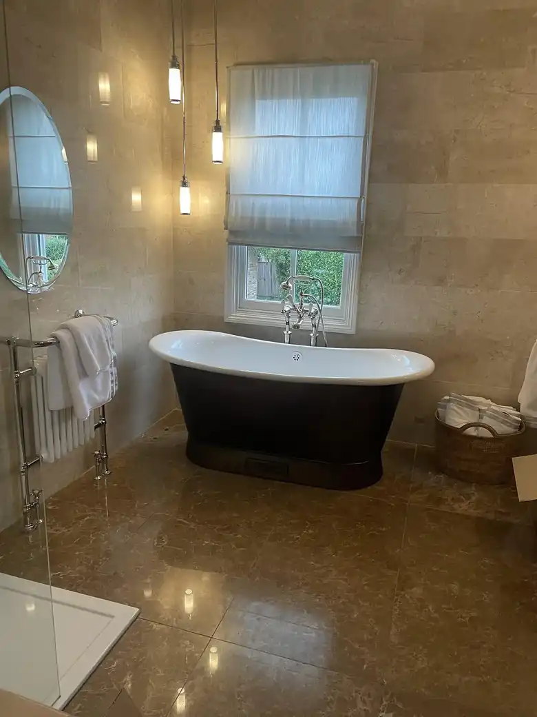 Roll top bath in a tiled bathroom