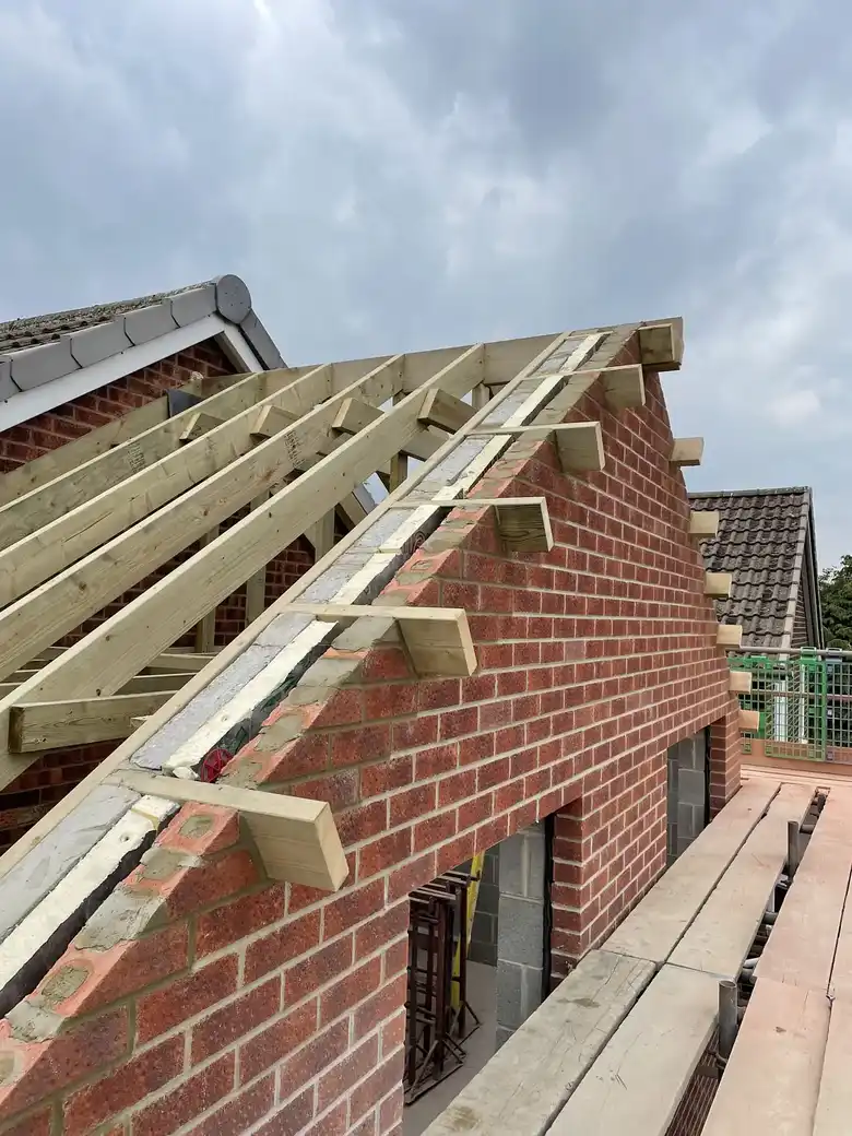 Roof trusses and gable on a brick extension