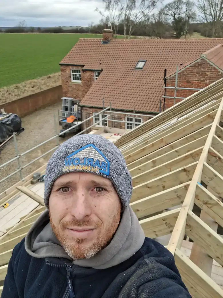 Roofer on the trusses of a new build