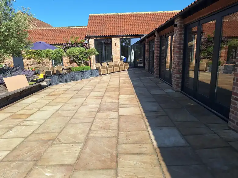 Sandstone courtyard in front of converted barns