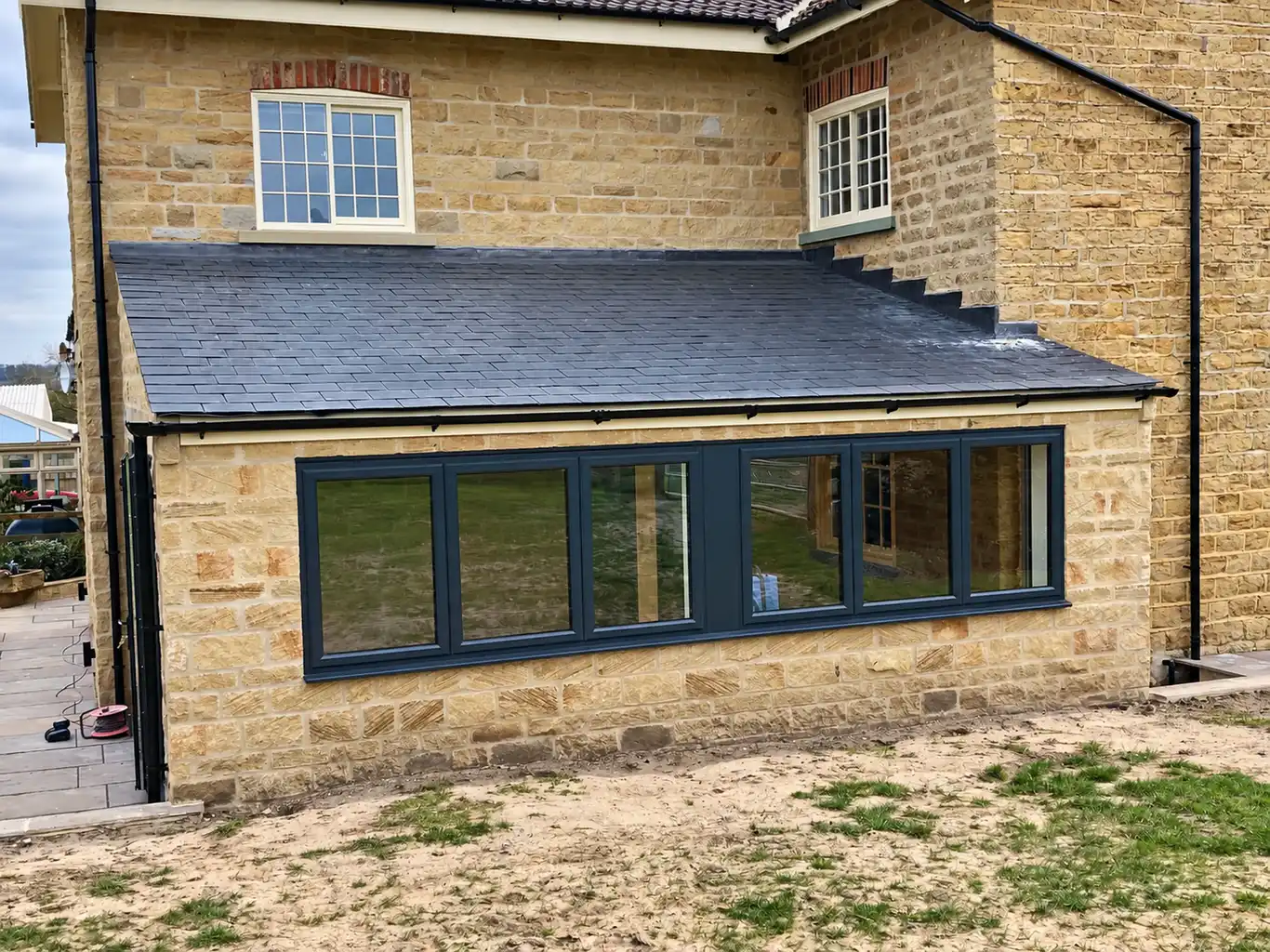 Stone extension with aluminium glazing