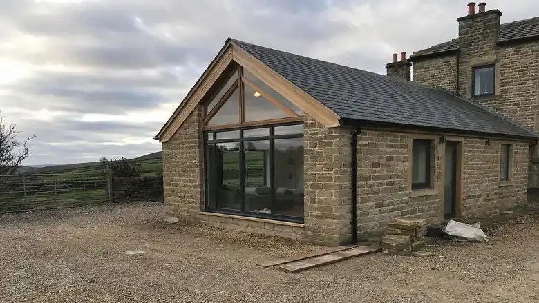 Stone extension with an oak framed glazed gable