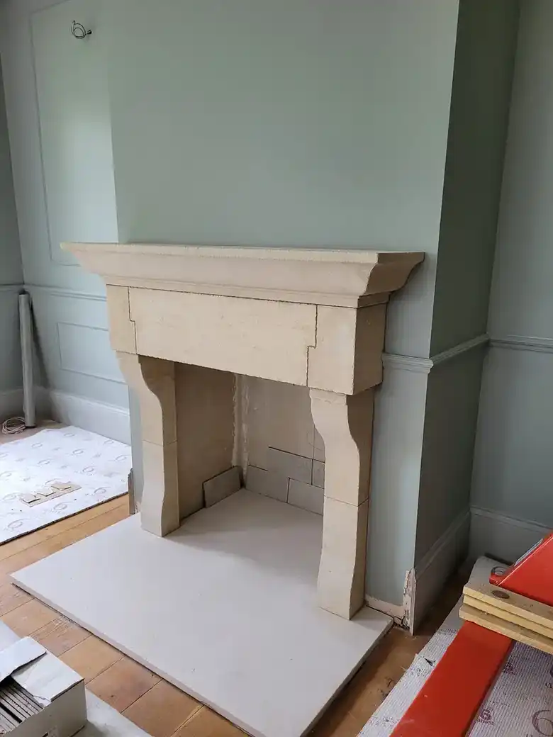 Stone fireplace surround in a painted room
