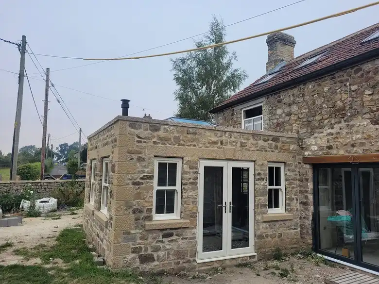 Stone outbuilding with French doors