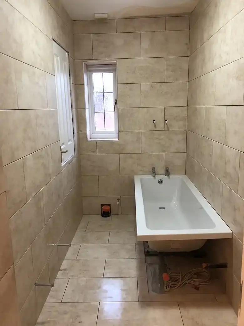 Tiled bathroom with a new bath