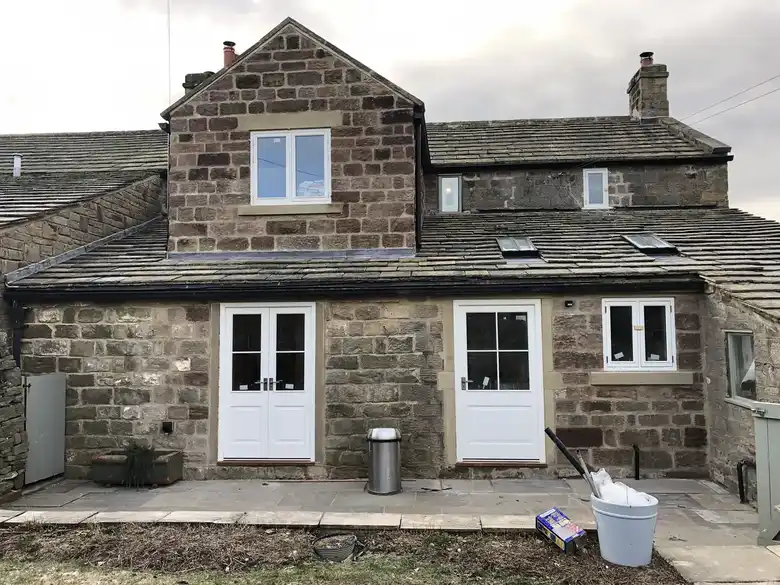 Two storey stone extension with French doors