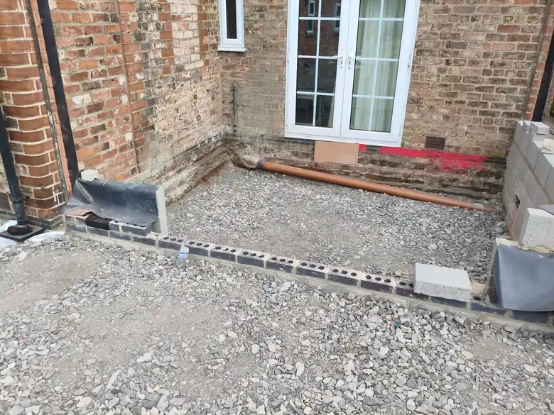 Walls up to damp proof course with the floor ready to fill