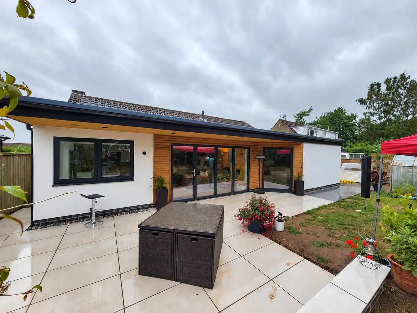White rendered extension with a patio