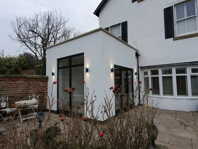 White rendered extension with wall lights